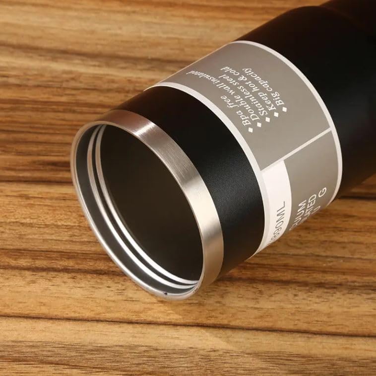 Close-up of a cylindrical container with a metal lid on a wooden surface