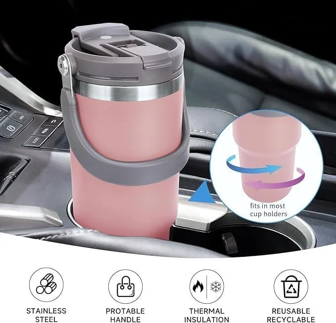 Pink insulated travel mug with cup holder feature on a car dashboard.