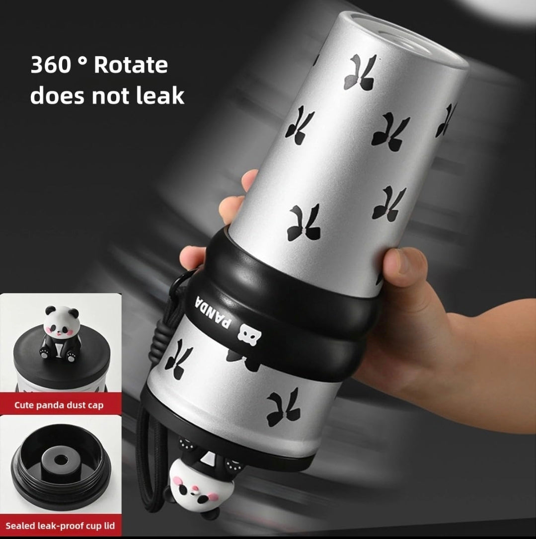 Hand holding a black panda tumbler blender with leak-proof design features.