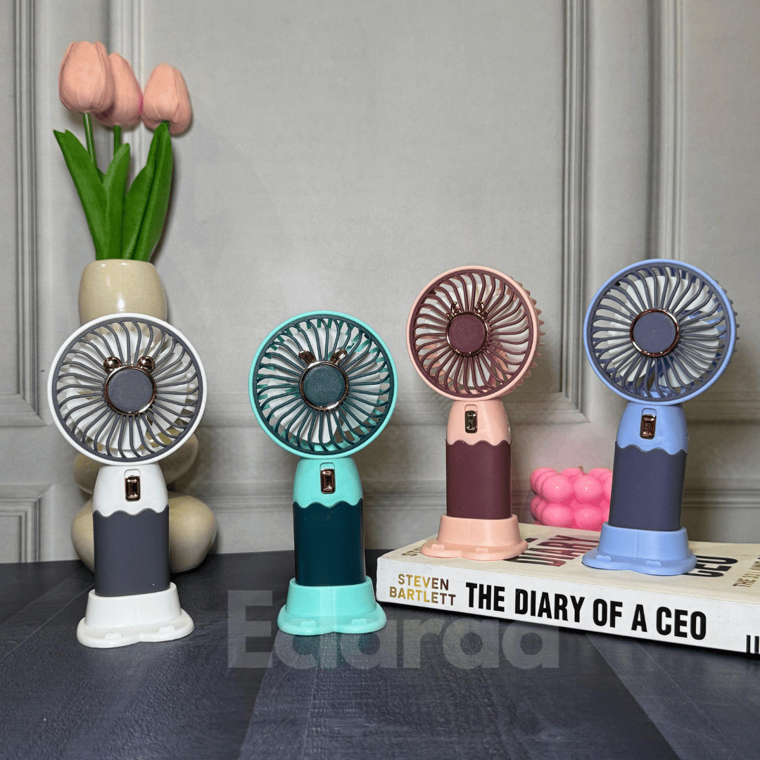Four colorful handheld fans on a surface (white, red, blue and mint green)