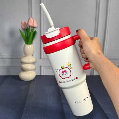 White tumbler with red lid and apple cartoon character print with straw and lid