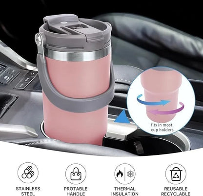 Pink insulated travel mug with cup holder feature on a car dashboard.