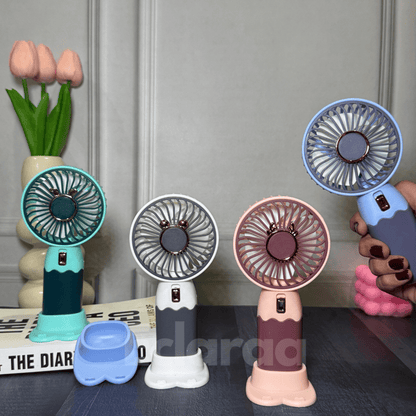 Four small handheld fans in different colors white , pink , mint green and blue