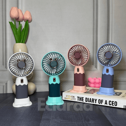 Four colorful handheld fans on a surface (white, red, blue and mint green) 